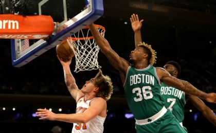 Oct 15, 2016; New York, NY, USA; New York Knicks forward Mindaugas Kuzminskas (91) goes up for a shot against Boston Celtics guard Marcus Smart (36) during the first half at Madison Square Garden. The Celtics won 119-107. Mandatory Credit: Andy Marlin-USA TODAY Sports