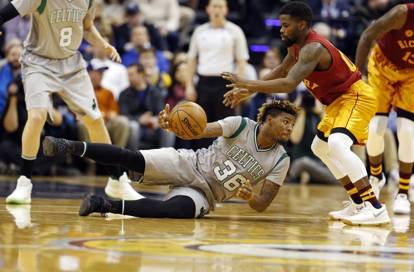 Dec 22, 2016; Indianapolis, IN, USA; Boston Celtics guard Marcus Smart (36) makes a pass while lying down against Indiana Pacers guard Aaron Brooks (00) at Bankers Life Fieldhouse. Boston defeats Indiana 109-102. Mandatory Credit: Brian Spurlock-USA TODAY Sports