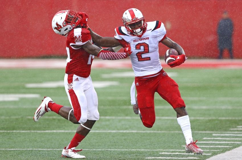 Sep 17, 2016; Oxford, OH, USA; Miami (Oh) Redhawks defensive back Tony Reid (14) is stiff armed by Western Kentucky Hilltoppers wide receiver Taywan Taylor (2) in the first half at Fred Yager Stadium. Mandatory Credit: Aaron Doster-USA TODAY Sports