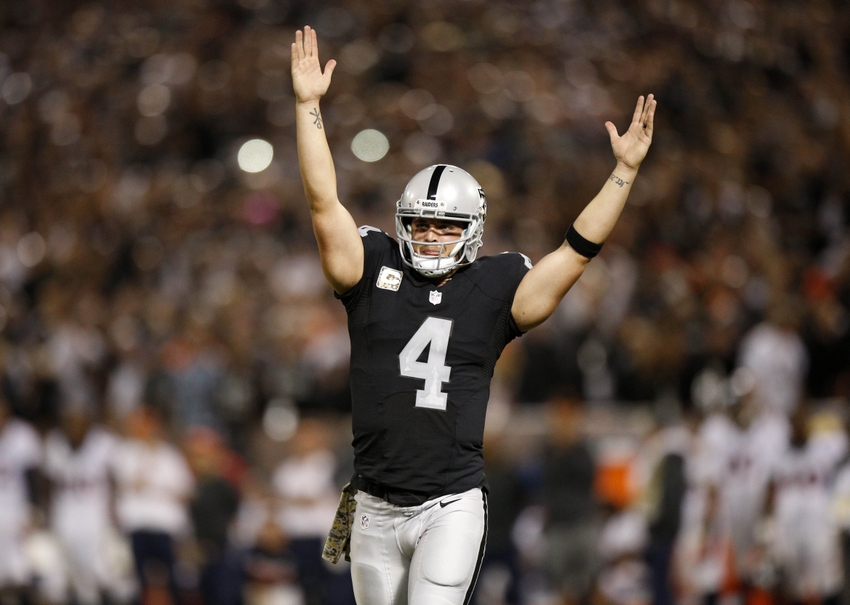 Nov 6, 2016; Oakland, CA, USA; Oakland Raiders quarterback Derek Carr (4) reacts after the Raiders rushed for a touchdown against the Denver Broncos in the fourth quarter at Oakland Coliseum. The Raiders defeated the Broncos 30-20. Mandatory Credit: Cary Edmondson-USA TODAY Sports