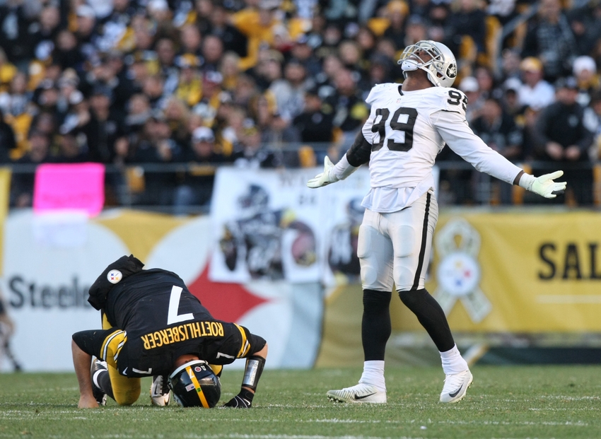 Nov 8, 2015; Pittsburgh, PA, USA; Oakland Raiders linebacker Aldon Smith (99) celebrates a sack as Pittsburgh Steelers quarterback Ben Roethlisberger (7) lays injured on the ground during the second half at Heinz Field. The Steelers won the game, 38-35. Mandatory Credit: Jason Bridge-USA TODAY Sports