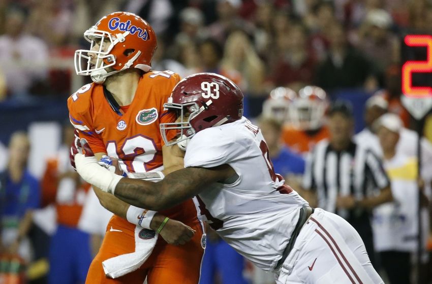 Dec 3, 2016; Atlanta, GA, USA; Florida Gators quarterback Austin Appleby (12) is tackled by Alabama Crimson Tide defensive lineman Jonathan Allen (93) during the second quarter of the SEC Championship college football game at Georgia Dome. Mandatory Credit: Jason Getz-USA TODAY Sports