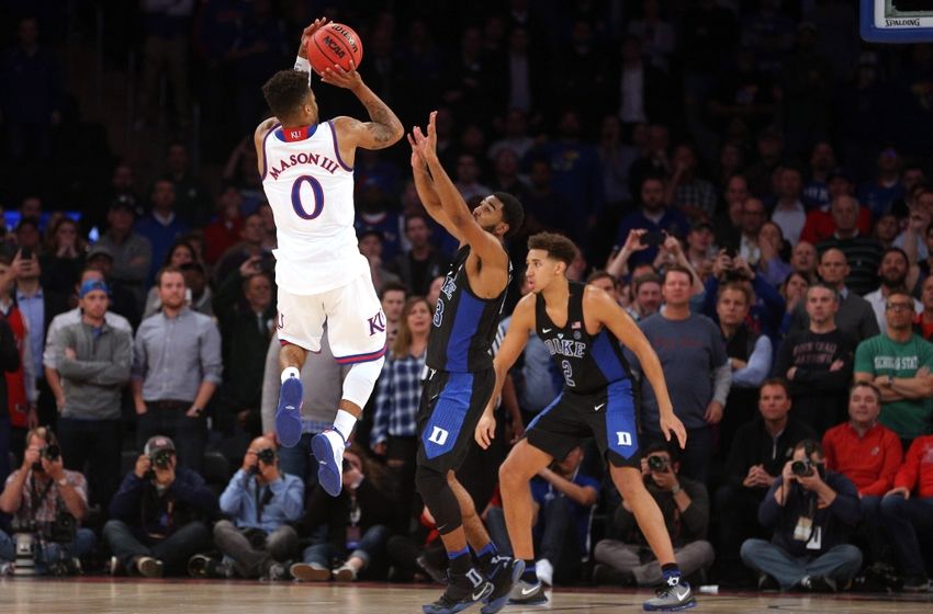 Nov 15, 2016; New York, NY, USA; Kansas Jayhawks guard Frank Mason (0) shoots the game winning shot against Duke Blue Devils guard Matt Jones (13) and forward Chase Jeter (2) during the second half at Madison Square Garden. Mandatory Credit: Brad Penner-USA TODAY Sports