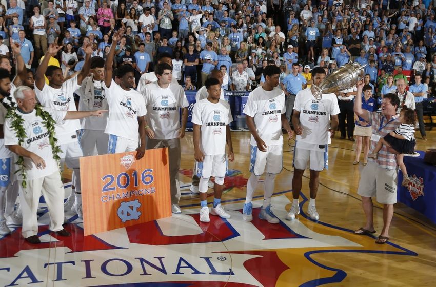 Nov 23, 2016; Lahaina, Maui, HI, USA; Walter Hester the CEO of Maui Jim presents the Wayne Duke Championship Trophy to North Carolina Tar Heels forwards Isaiah Hicks and Kennedy Meeks after defeating the Wisconsin Badgers in the Championship Game of the Maui Jim Maui Invitational at the Lahaina Civic Center. Mandatory Credit: Brian Spurlock-USA TODAY Sports