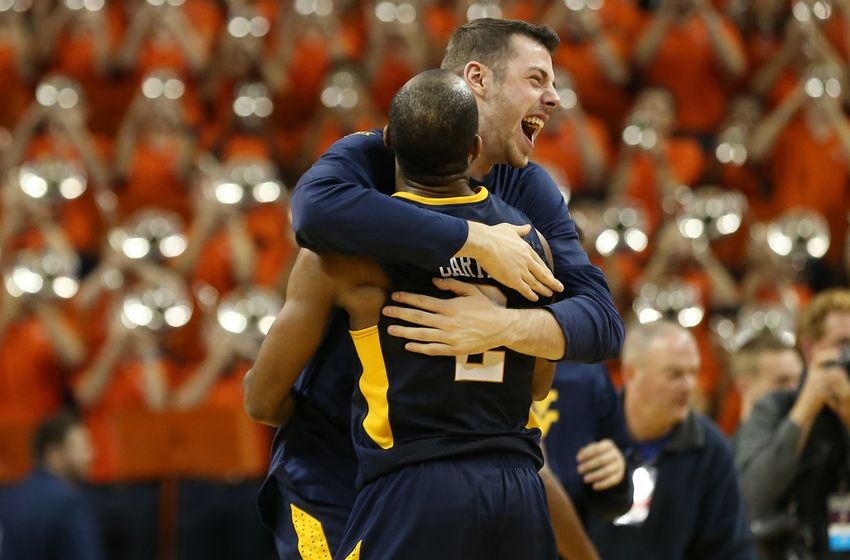 Dec 3, 2016; Charlottesville, VA, USA; West Virginia Mountaineers guard Jevon Carter (2) and Mountaineers forward Maciej Bender (R) celebrate after their game against the Virginia Cavaliers at John Paul Jones Arena. The Mountaineers won 66-57. Mandatory Credit: Geoff Burke-USA TODAY Sports