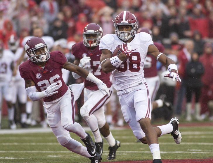 Oct 11, 2014; Fayetteville, AR, USA; Alabama Crimson Tide tight end O.J. Howard (88) carries the ball as Arkansas Razorbacks safety Rohan Gaines (26) and linebacker Martrell Spaight (47) attempt to tackle during the first half of a game at Donald W. Reynolds Razorback Stadium. Mandatory Credit: Beth Hall-USA TODAY Sports