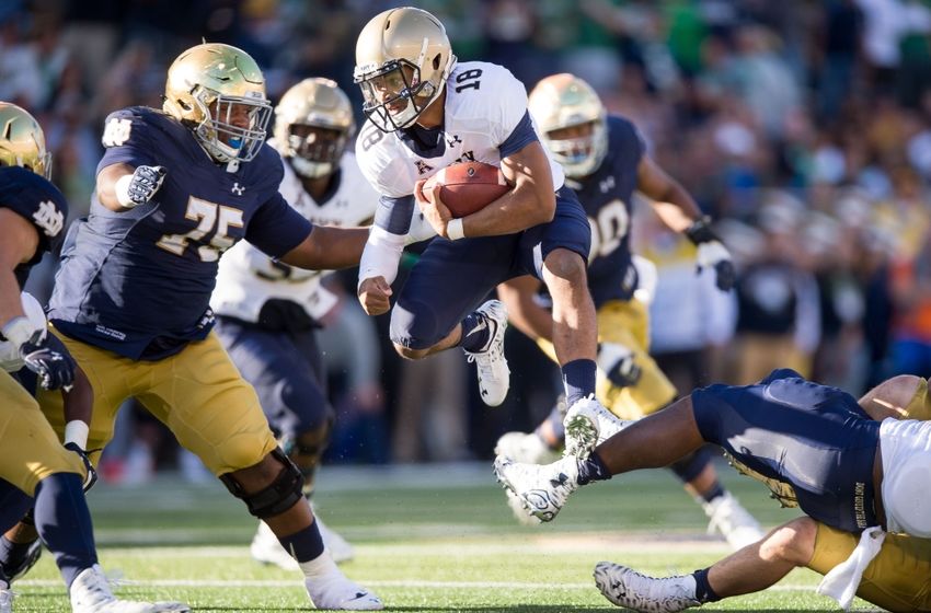 Oct 10, 2015; South Bend, IN, USA; Navy Midshipmen quarterback Tago Smith (18) runs the ball as Notre Dame Fighting Irish defensive lineman Daniel Cage (75) defends in the second quarter at Notre Dame Stadium. Mandatory Credit: Matt Cashore-USA TODAY Sports