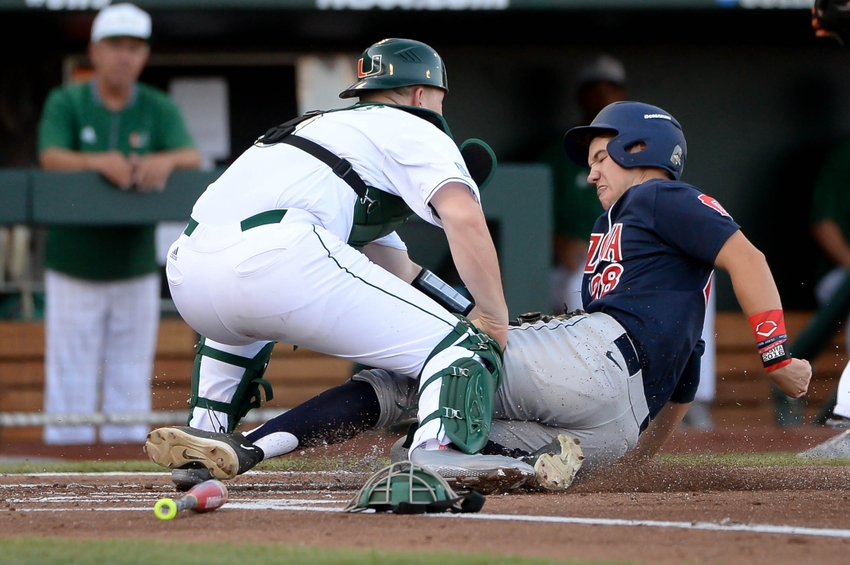 Jun 18, 2016; Omaha, NE, USA; Miami Hurricanes catcher Zack Collins (0) tags out Arizona Wildcats infielder Kyle Lewis (28) for the third out in the first inning in the 2016 College World Series at TD Ameritrade Park. Mandatory Credit: Steven Branscombe-USA TODAY Sports