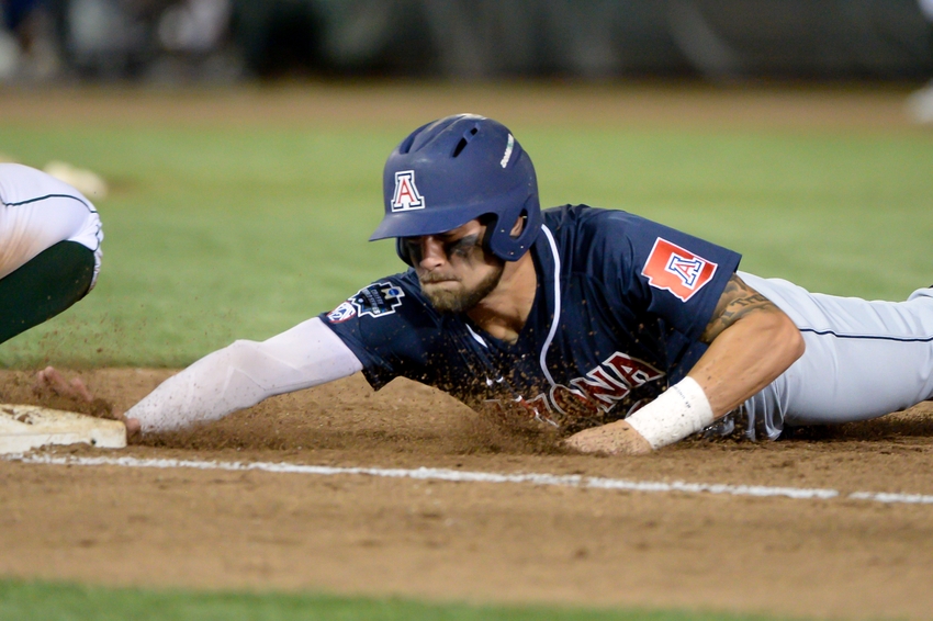 Jun 18, 2016; Omaha, NE, USA; Arizona Wildcats infielder JJ Matijevic (24) slides back into first base against the Miami Hurricanes in the eighth inning in the 2016 College World Series at TD Ameritrade Park. Arizona defeated Miami 5-1. Mandatory Credit: Steven Branscombe-USA TODAY Sports