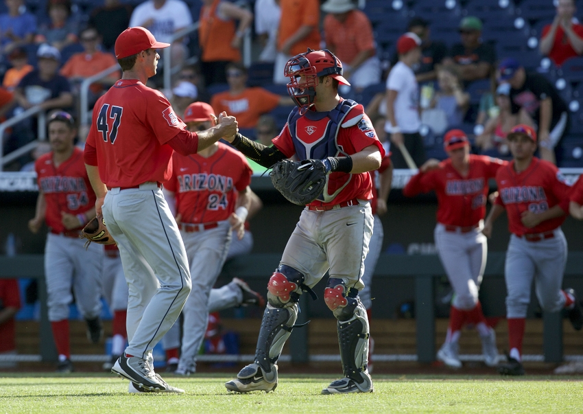 Jun 24, 2016; Omaha, NE, USA; Arizona Wildcats pitcher Cameron Ming (47) and catcher Collin Theroux (12) celebrate after defeating the Oklahoma State Cowboys in the College World Series at TD Ameritrade Park. Arizona won 9-3. Mandatory Credit: Bruce Thorson-USA TODAY Sports