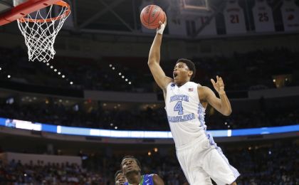 Mar 17, 2016; Raleigh, NC, USA; North Carolina Tar Heels forward Isaiah Hicks (4) attempts to dunk the ball in front of Florida Gulf Coast Eagles forward Marc Eddy Norelia (25) during the first half at PNC Arena. Mandatory Credit: Geoff Burke-USA TODAY Sports