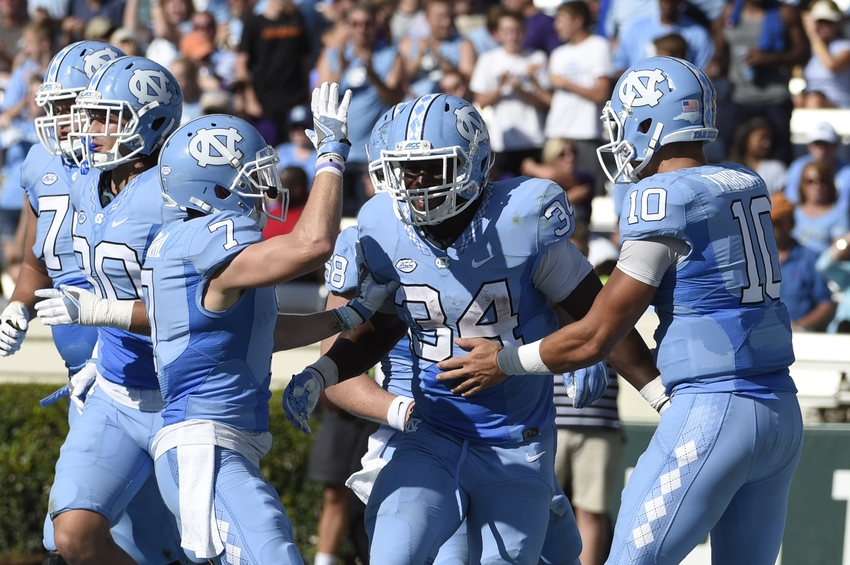 Sep 17, 2016; Chapel Hill, NC, USA; North Carolina Tar Heels running back Elijah Hood (34) celebrates after scoring a touchdown with wide receiver Austin Proehl (7) and quarterback Mitch Trubisky (10) at Kenan Memorial Stadium. The Tar Heels defeated the James Madison Dukes 56-28. Mandatory Credit: Bob Donnan-USA TODAY Sports