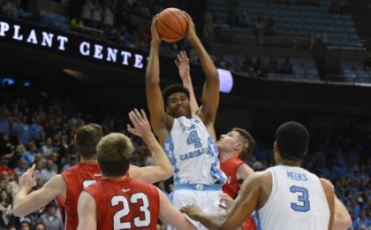 Dec 7, 2016; Chapel Hill, NC, USA; North Carolina Tar Heels forward Isaiah Hicks (4) pulls down a rebound in front of Davidson Wildcats guard Jon Axel Gudmundsson (3) during the second half at Dean E. Smith Center. The Tar Heels won 83-74. Mandatory Credit: Rob Kinnan-USA TODAY Sports