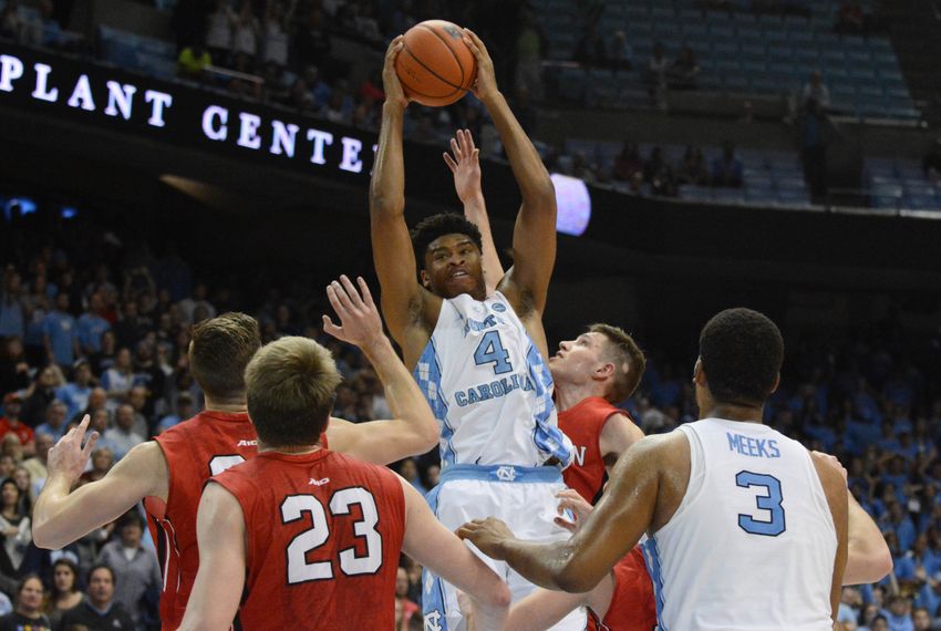 Dec 7, 2016; Chapel Hill, NC, USA; North Carolina Tar Heels forward Isaiah Hicks (4) pulls down a rebound in front of Davidson Wildcats guard Jon Axel Gudmundsson (3) during the second half at Dean E. Smith Center. The Tar Heels won 83-74. Mandatory Credit: Rob Kinnan-USA TODAY Sports
