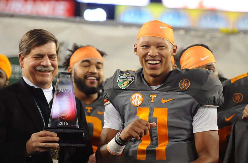 Dec 30, 2016; Nashville , TN, USA; Tennessee Volunteers quarterback Joshua Dobbs (11) is awarded the Music City Bowl MVP trophy after a win over the Nebraska Cornhuskers at Nissan Stadium. Tennessee won 38-24.Mandatory Credit: Christopher Hanewinckel-USA TODAY Sports