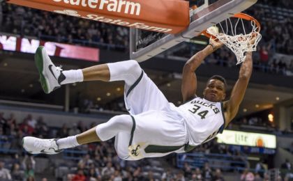 Nov 5, 2016; Milwaukee, WI, USA; Milwaukee Bucks forward Giannis Antetokounmpo (34) hangs onto the rim after dunking for a basket in the third quarter during the game against the Sacramento Kings at BMO Harris Bradley Center. The Bucks beat the Kings 117-91. Mandatory Credit: Benny Sieu-USA TODAY Sports