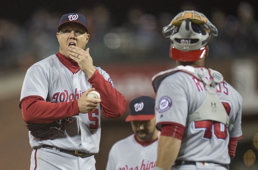 Jul 28, 2016; San Francisco, CA, USA; Washington Nationals relief pitcher Jonathan Papelbon (58) prepares to give the ball to Washington Nationals manager Dusty Baker (not pictured) while Washington Nationals catcher Wilson Ramos (40) looks on during the ninth inning against the San Francisco Giants at AT&T Park. Mandatory Credit: Kenny Karst-USA TODAY Sports