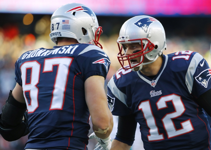 Dec 14, 2014; Foxborough, MA, USA; New England Patriots quarterback Tom Brady (12) celebrates with tight end Rob Gronkowski (87) after catching the ball to score a touchdown during the second half against the Miami Dolphins at Gillette Stadium. The Patriots won 41-13. Mandatory Credit: Winslow Townson-USA TODAY Sports