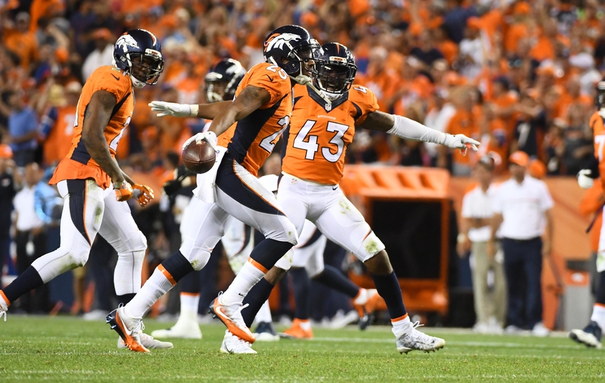 Sep 8, 2016; Denver, CO, USA; Denver Broncos cornerback Chris Harris (25) celebrates his interception with Denver Broncos cornerback Aqib Talib (21) and strong safety T.J. Ward (43) in the fourth quarter against the Carolina Panthers at Sports Authority Field at Mile High. Mandatory Credit: Ron Chenoy-USA TODAY Sports