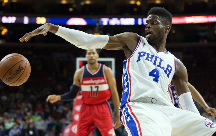 Mar 17, 2016; Philadelphia, PA, USA; Philadelphia 76ers forward Nerlens Noel (4) reaches for a ball and keeps it in bounds against the Washington Wizards during the second quarter at Wells Fargo Center. Mandatory Credit: Bill Streicher-USA TODAY Sports