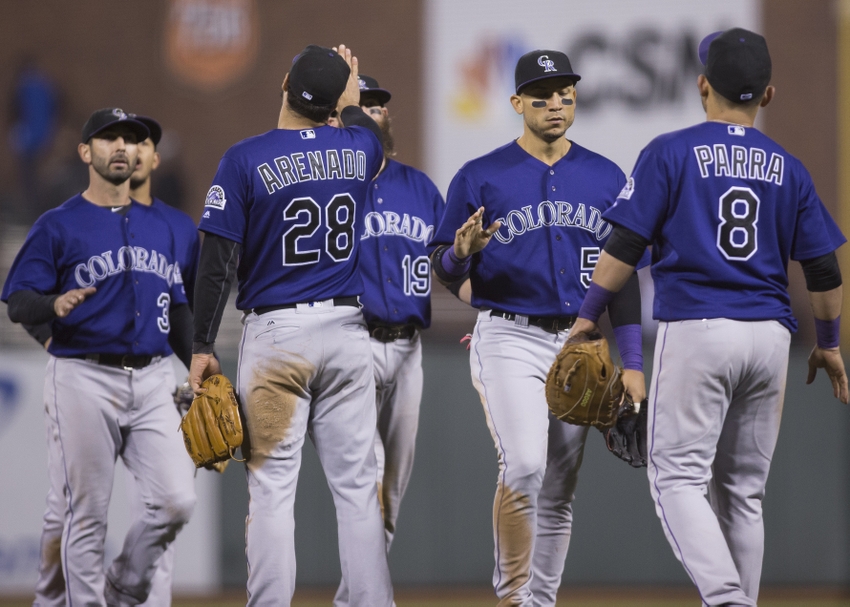 Sep 28, 2016; San Francisco, CA, USA; Colorado Rockies third baseman Nolan Arenado (28) and right fielder Hunter Pence (8) and shortstop Daniel Descalso (3) and center fielder Charlie Blackmon (19) and right fielder Carlos Gonzalez (5) celebrate after the end of the game against the San Francisco Giants at AT&T Park the Colorado Rockies defeated the San Francisco Giants 2 to 0. Mandatory Credit: Neville E. Guard-USA TODAY Sports