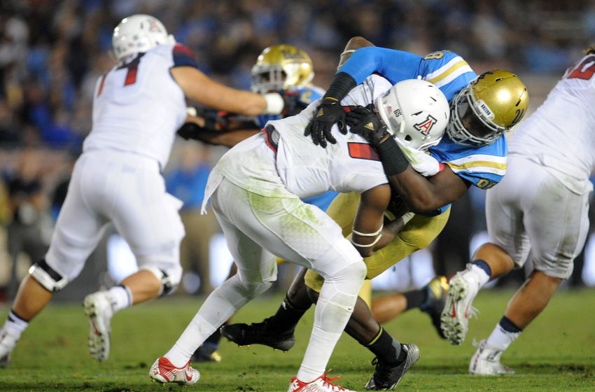 October 1, 2016; Pasadena, CA, USA; UCLA Bruins defensive lineman Takkarist McKinley (98) brings down Arizona Wildcats quarterback Khalil Tate (14) during the second half at Rose Bowl. Mandatory Credit: Gary A. Vasquez-USA TODAY Sports