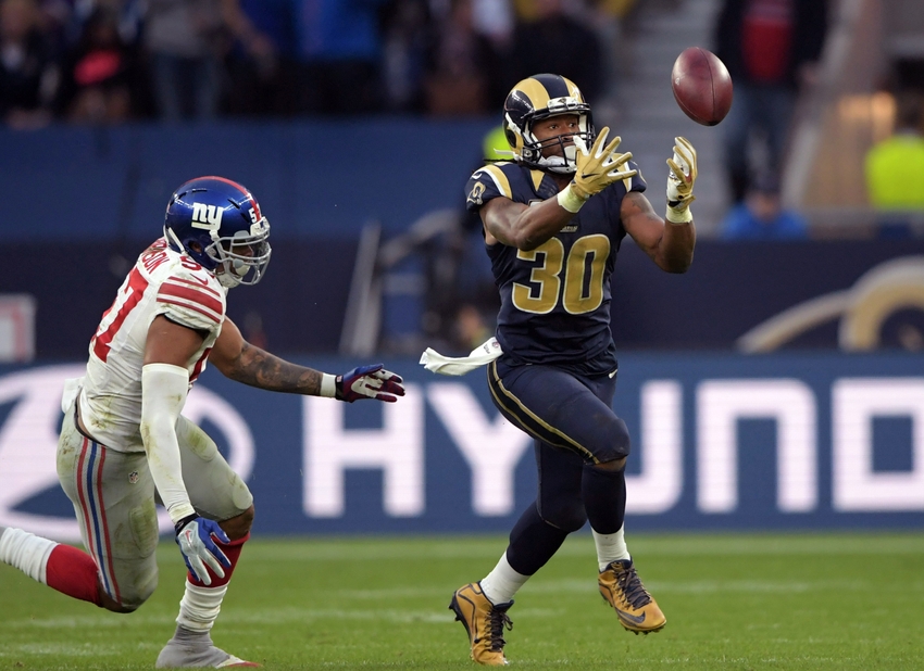Oct 23, 2016; London, United Kingdom; Los Angeles Rams running back Todd Gurley (30) catches a pass as New York Giants linebacker Keenan Robinson (57) defends during game 16 of the NFL International Series at Twickenham Statdium. The Giants defeated the Rams 17-10. Mandatory Credit: Kirby Lee-USA TODAY Sports