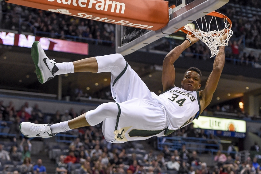 Nov 5, 2016; Milwaukee, WI, USA; Milwaukee Bucks forward Giannis Antetokounmpo (34) hangs onto the rim after dunking for a basket in the third quarter during the game against the Sacramento Kings at BMO Harris Bradley Center. The Bucks beat the Kings 117-91. Mandatory Credit: Benny Sieu-USA TODAY Sports