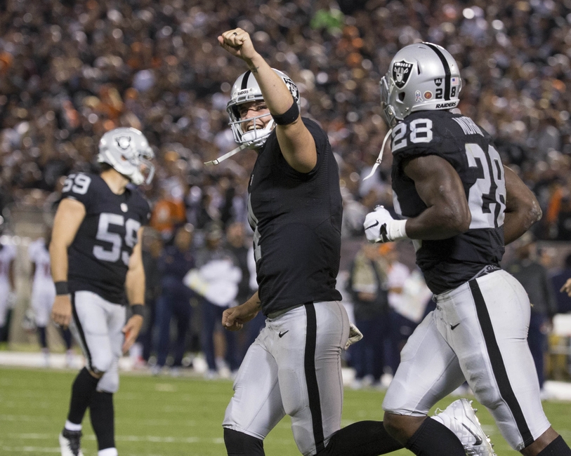 Nov 6, 2016; Oakland, CA, USA; Oakland Raiders quarterback Derek Carr (4) celebrates after a touchdown in the second quarter against the Denver Broncos at Oakland Coliseum. Mandatory Credit: Neville E. Guard-USA TODAY Sports