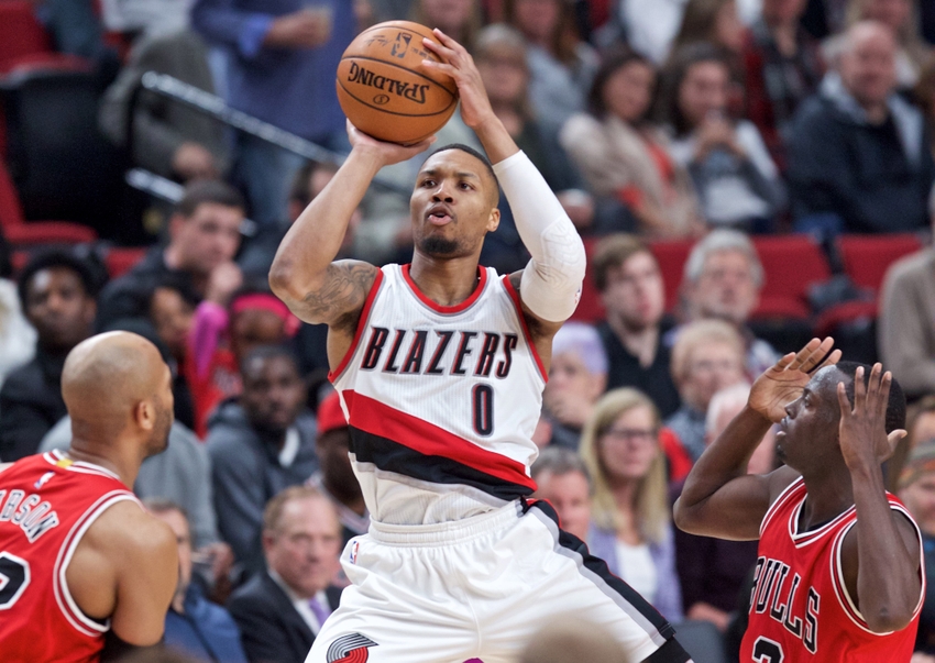 Nov 15, 2016; Portland, OR, USA; Portland Trail Blazers guard Damian Lillard (0) shoots over Chicago Bulls forward Taj Gibson (22) and guard Jerian Grant (2) during the third quarter at the Moda Center. Mandatory Credit: Craig Mitchelldyer-USA TODAY Sports