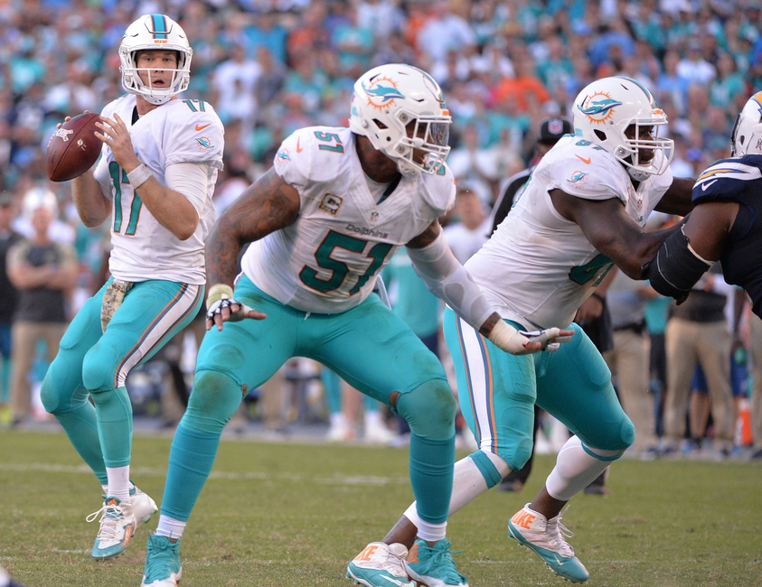 Nov 13, 2016; San Diego, CA, USA; Miami Dolphins quarterback Ryan Tannehill (17) looks to pass while protected by center Mike Pouncey (51) and offensive guard Laremy Tunsil (67) during the second half against the San Diego Chargers at Qualcomm Stadium. Miami won 31-24. Mandatory Credit: Orlando Ramirez-USA TODAY Sports
