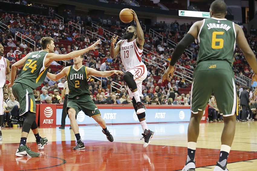 Nov 19, 2016; Houston, TX, USA; Houston Rockets guard James Harden (13) drives to the basket against Utah Jazz center Jeff Withey (24) and forward Joe Ingles (2) in the second half at Toyota Center. Rockets won 111-102. Mandatory Credit: Thomas B. Shea-USA TODAY Sports