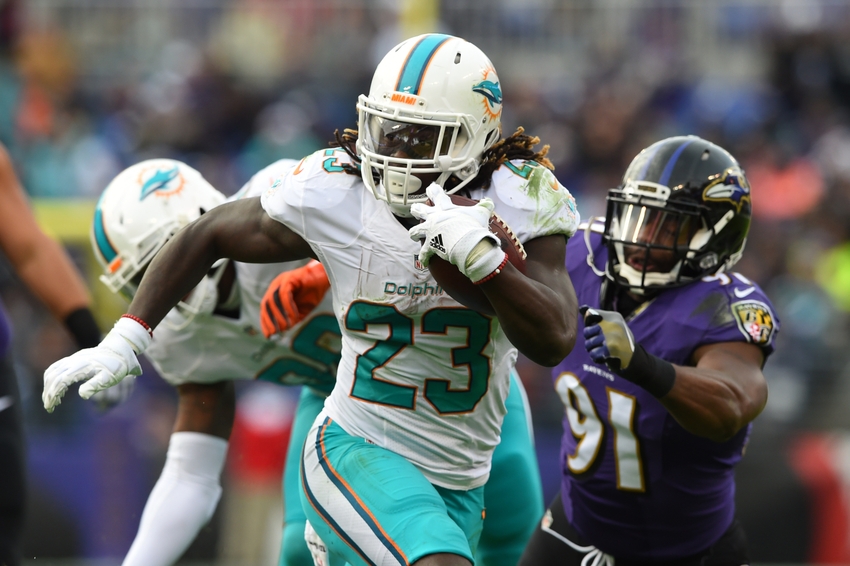 Dec 4, 2016; Baltimore, MD, USA; Miami Dolphins running back Jay Ajayi (23) runs past Baltimore Ravens linebacker Matt Judon (91) during the second half at M&T Bank Stadium. Baltimore Ravens defeated Miami Dolphins 38-6. Mandatory Credit: Tommy Gilligan-USA TODAY Sports