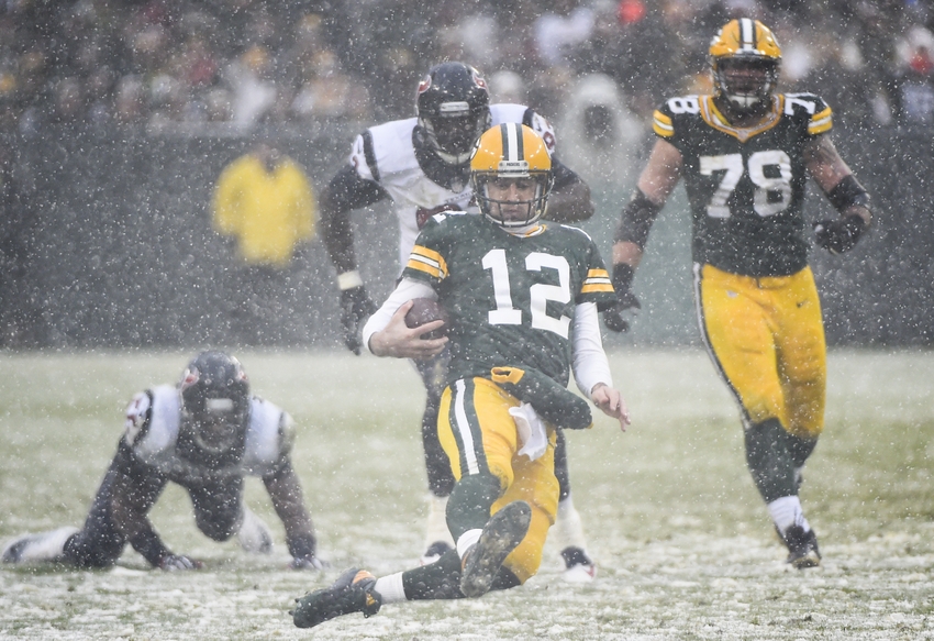 Dec 4, 2016; Green Bay, WI, USA; Green Bay Packers quarterback Aaron Rodgers (12) scrambles for a first down in the fourth quarter during the game against the Houston Texans at Lambeau Field. Mandatory Credit: Benny Sieu-USA TODAY Sports