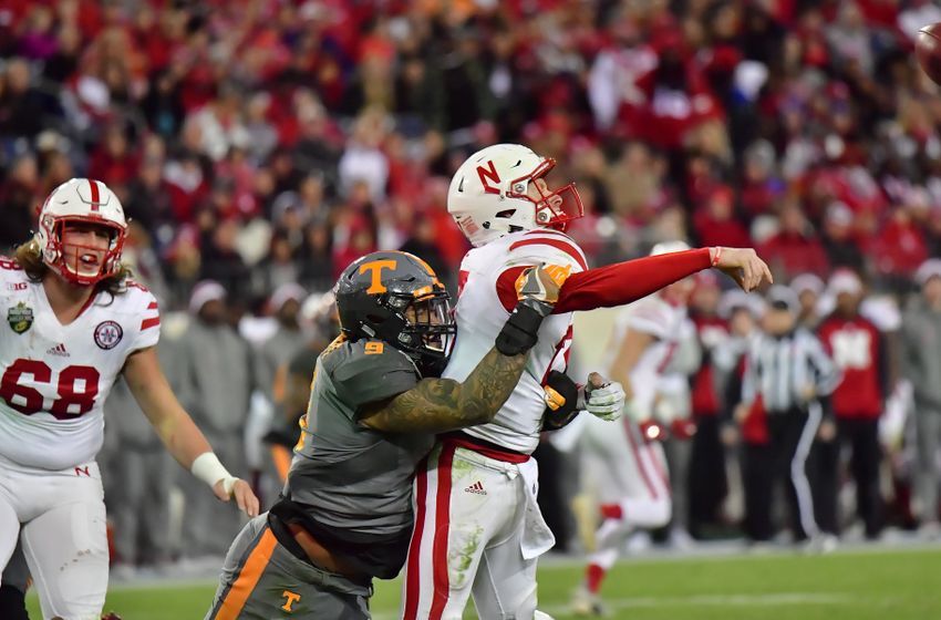 Dec 30, 2016; Nashville , TN, USA; Nebraska Cornhuskers quarterback Ryker Fyfe (17) throws the ball as Tennessee Volunteers defensive end Derek Barnett (9) defends during the second half at Nissan Stadium. Mandatory Credit: Jim Brown-USA TODAY Sports