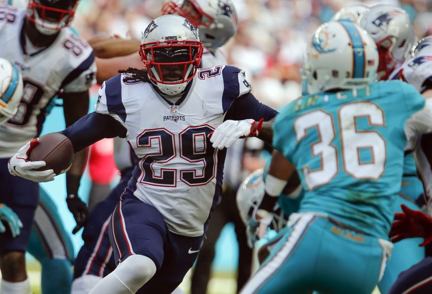 Jan 1, 2017; Miami Gardens, FL, USA; New England Patriots running back LeGarrette Blount (29) runs toward Miami Dolphins cornerback Tony Lippett (36) during the second quarter of an NFL football game at Hard Rock Stadium. Mandatory Credit: Reinhold Matay-USA TODAY Sports