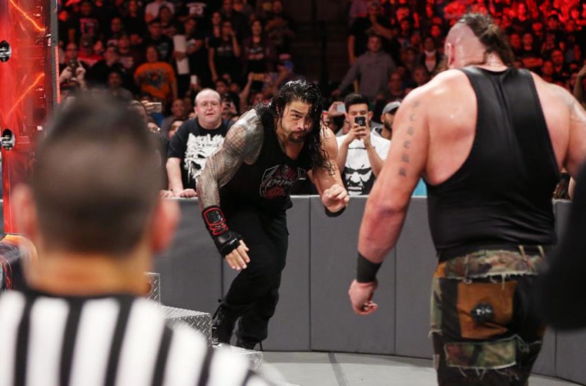 Roman Reigns hits a Spear on Braun Strowman.