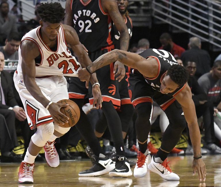 Jan 7, 2017; Chicago, IL, USA; Chicago Bulls forward Jimmy Butler (21) and Toronto Raptors guard DeMar DeRozan (10) go for the ball during the second half at the United Center. The Bulls won 123-118 in overtime. Mandatory Credit: David Banks-USA TODAY Sports