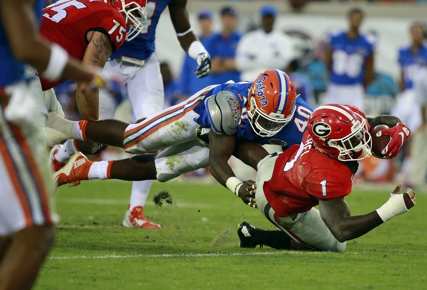 Oct 31, 2015; Jacksonville, FL, USA; Georgia Bulldogs running back Sony Michel (1) runs with the ball as Florida Gators linebacker Jarrad Davis (40) defends during the second half at EverBank Stadium. Florida Gators defeated the Georgia Bulldogs 27-3. Mandatory Credit: Kim Klement-USA TODAY Sports