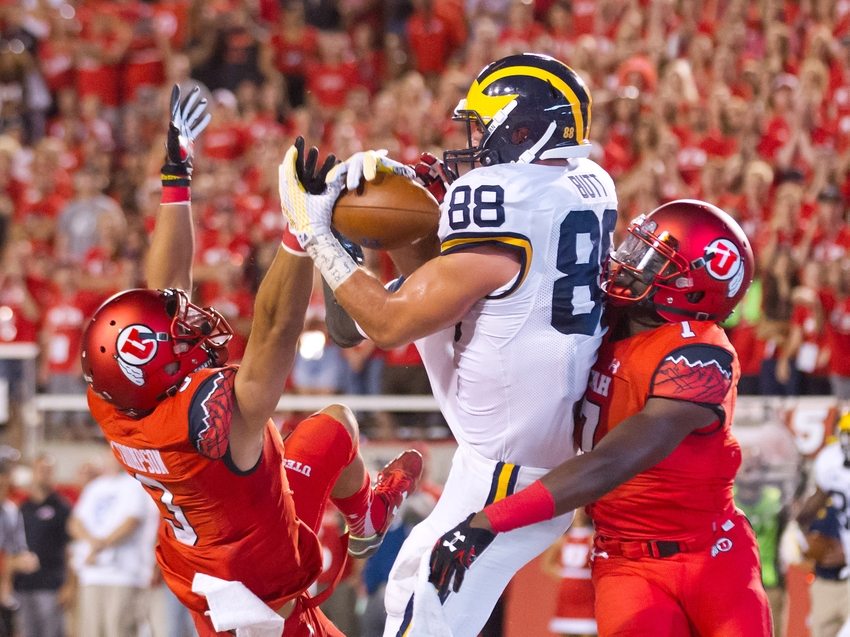 Sep 3, 2015; Salt Lake City, UT, USA; Michigan Wolverines tight end Jake Butt (88) catches a touchdown pass while defended by Utah Utes defensive back Jason Thompson (3) and defensive back Andre Godfrey (7) during the second half at Rice-Eccles Stadium. Utah won 24-17. Mandatory Credit: Russ Isabella-USA TODAY Sports