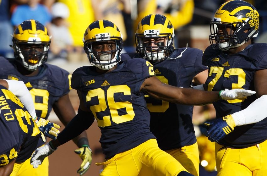 Oct 10, 2015; Ann Arbor, MI, USA; Michigan Wolverines cornerback Jourdan Lewis (26) celebrates with teammates after he scores a touchdown on an interception in the second quarter against the Northwestern Wildcats at Michigan Stadium. Mandatory Credit: Rick Osentoski-USA TODAY Sports