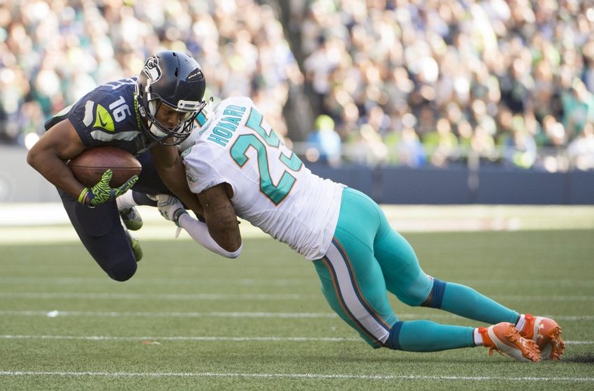 Sep 11, 2016; Seattle, WA, USA; Miami Dolphins cornerback Xavien Howard (25) tackles Seattle Seahawks wide receiver Tyler Lockett (16) during the fourth quarter at CenturyLink Field. The Seahawks won 12-10. Mandatory Credit: Troy Wayrynen-USA TODAY Sports