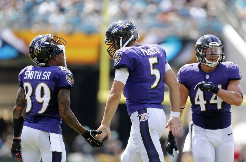 Sep 25, 2016; Jacksonville, FL, USA; Baltimore Ravens quarterback Joe Flacco (5) celebrates with wide receiver Steve Smith (89) and fullback Kyle Juszczyk (44) after scoring a touchdown in the first quarter against the Jacksonville Jaguars at EverBank Field. Mandatory Credit: Logan Bowles-USA TODAY Sports