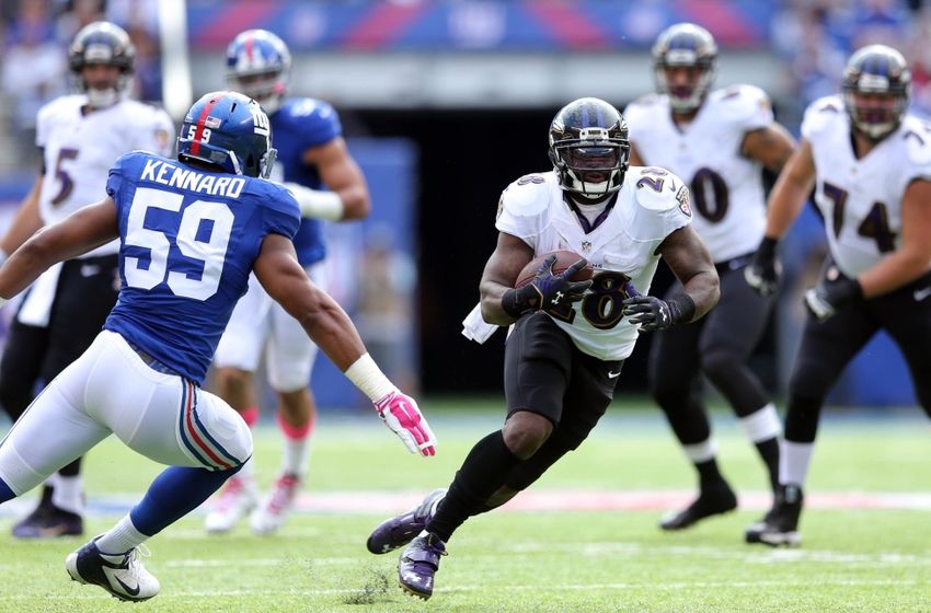 Oct 16, 2016; East Rutherford, NJ, USA; Baltimore Ravens running back Terrance West (28) runs the ball against New York Giants linebacker Devon Kennard (59) during the first quarter at MetLife Stadium. Mandatory Credit: Brad Penner-USA TODAY Sports