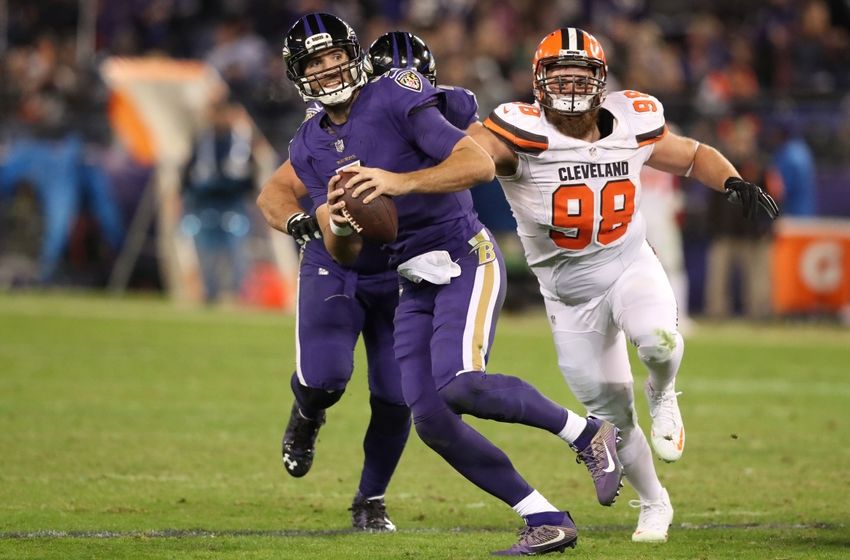 Nov 10, 2016; Baltimore, MD, USA; Baltimore Ravens quarterback Joe Flacco (5) runs from defensive pressure from Cleveland Browns defensive lineman Jamie Meder (98) at M&T Bank Stadium. Mandatory Credit: Mitch Stringer-USA TODAY Sports