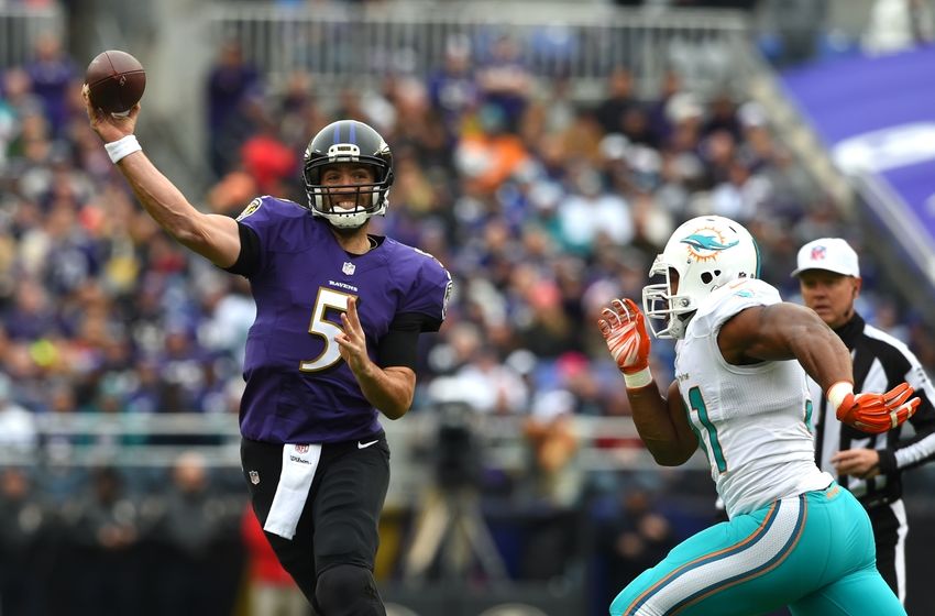 Dec 4, 2016; Baltimore, MD, USA; Baltimore Ravens quarterback Joe Flacco (5) throws as Miami Dolphins center Mike Pouncey (51) applies pressure during the first quarter at M&T Bank Stadium. Mandatory Credit: Tommy Gilligan-USA TODAY Sports