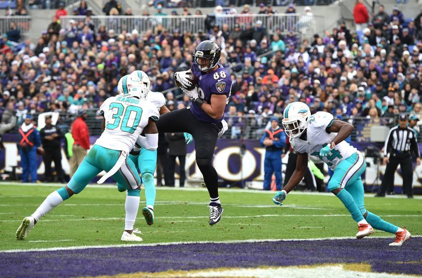 Dec 4, 2016; Baltimore, MD, USA; Baltimore Ravens tight end Dennis Pitta (88) catches pass for a touchdown from quarterback Joe Flacco (not pictured) in front of Miami Dolphins free safety Bacarri Rambo (30) and linebacker Spencer Paysinger (42) during the first quarter at M&T Bank Stadium. Mandatory Credit: Tommy Gilligan-USA TODAY Sports
