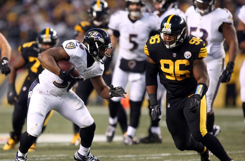Dec 25, 2016; Pittsburgh, PA, USA; Baltimore Ravens running back Kenneth Dixon (30) runs after a catch against Pittsburgh Steelers defensive tackle L.T. Walton (96) during the first quarter at Heinz Field. Mandatory Credit: Charles LeClaire-USA TODAY Sports