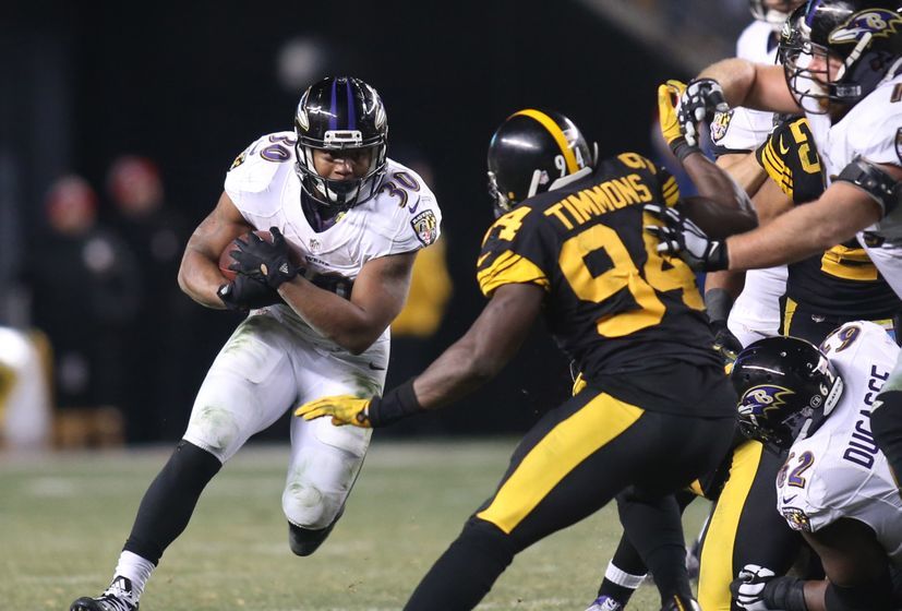 Dec 25, 2016; Pittsburgh, PA, USA; Baltimore Ravens running back Kenneth Dixon (30) rushes the ball against Pittsburgh Steelers inside linebacker Lawrence Timmons (94) during the fourth quarter at Heinz Field. The Steelers won 31-27. Mandatory Credit: Charles LeClaire-USA TODAY Sports
