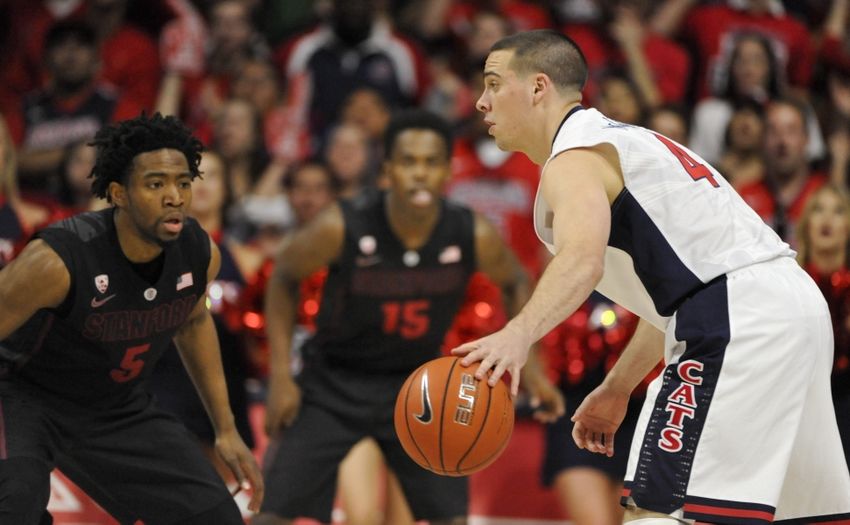 Mar 7, 2015; Tucson, AZ, USA; Arizona Wildcats guard T.J. McConnell (4) dribbles the ball as he is defended by Stanford Cardinal guard Chasson Randle (5) during the first half at McKale Center. Mandatory Credit: Casey Sapio-USA TODAY Sports